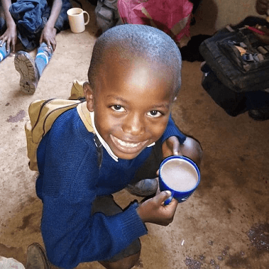 Little boy drinking milk with a big smile