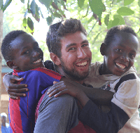 Volunteer playing with African children